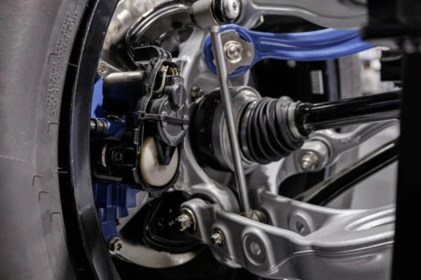 Close-up-view-of-suspension-components-showing-signs-of-wear-including-the-pin-or-bush-worn