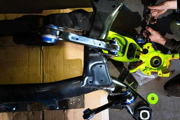 Mechanic-working-on-suspension-arm-pin-or-bush-worn