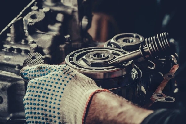 Technician-handling-a-gearbox-component-with-care-focusing-on-the-intricacies-of-gearbox-servicing