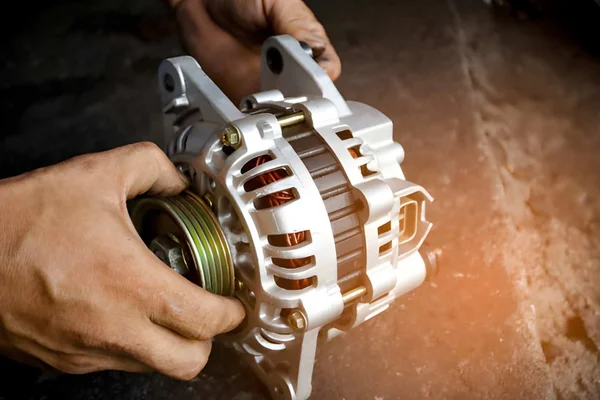 alternator-repair-mechanic-holding-a-replacement-alternator