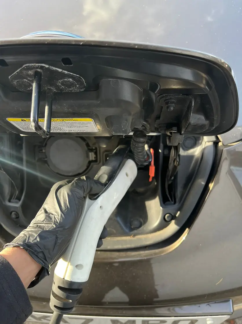 electric-vehicle-charging-connector-plugged-into-a-tesla