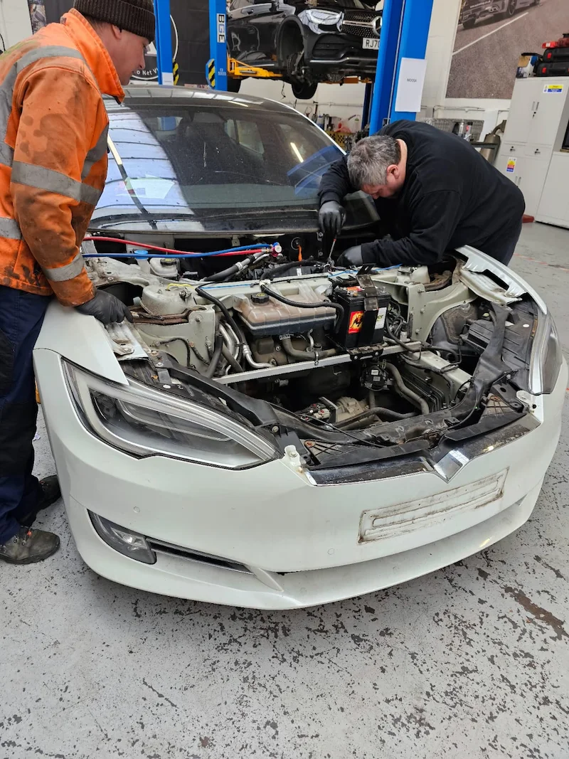 technicians-performing-tesla-electric-vehicle-repairs-in-harlow