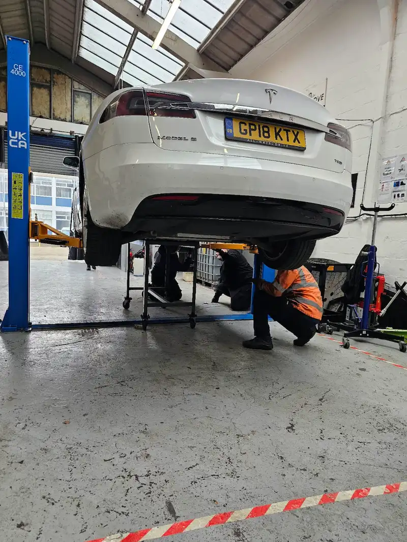 tesla-model-s-raised-on-a-lift-for-electric-vehicle-repairs