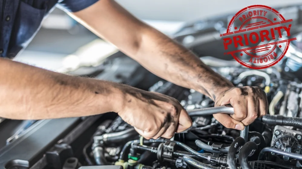 Mechanic-repairing-a-car-engine-with-a-red-Priority-stamp,-representing-AutoNet-Priority-Lane-fast-track-repair-services